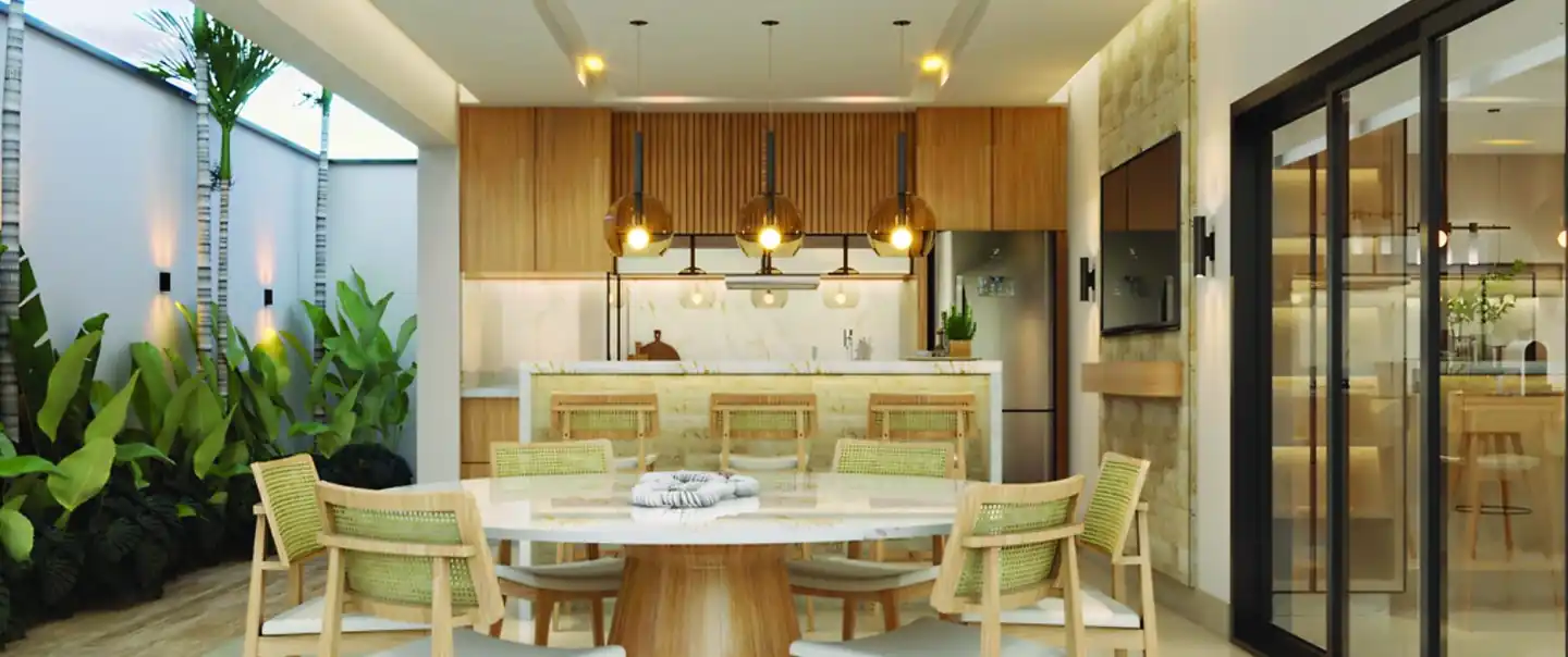 Espaço gourmet com mesa redonda, cadeiras de palhinha e jardim ao lado